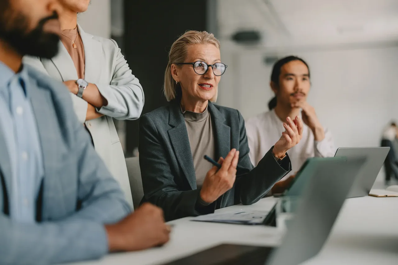 Business professionals collaborating on data governance policies in an office meeting