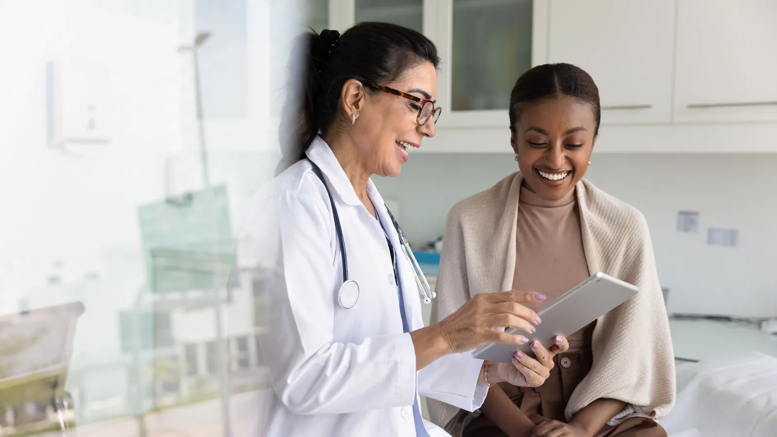 A doctor and patient consultation with digital note-taking
