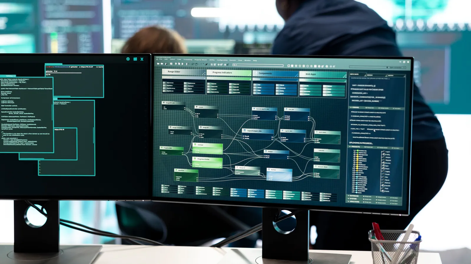 A cybersecurity operations-centre analyst at multiple monitors