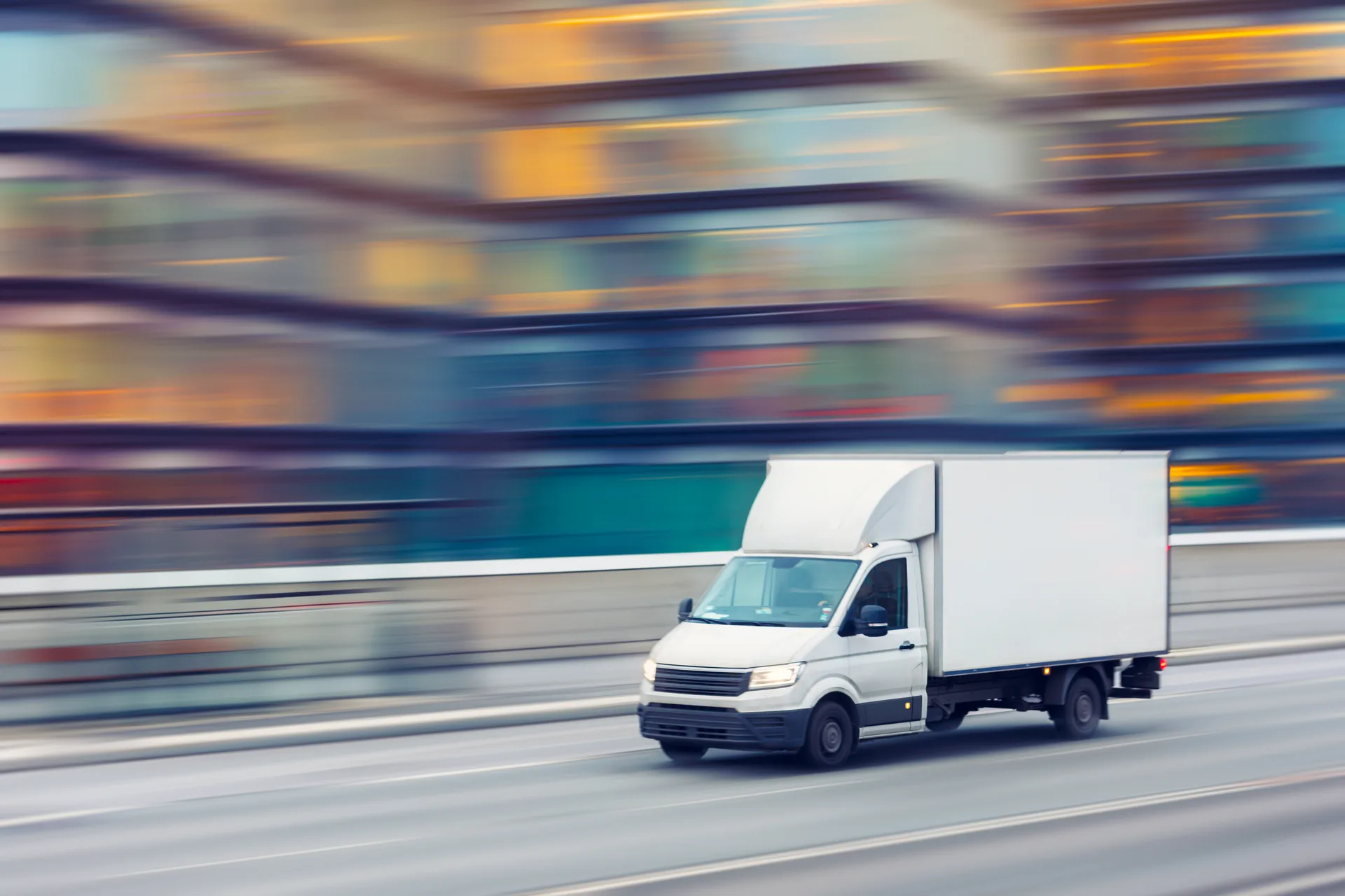 Fast delivery truck travelling through the city streets