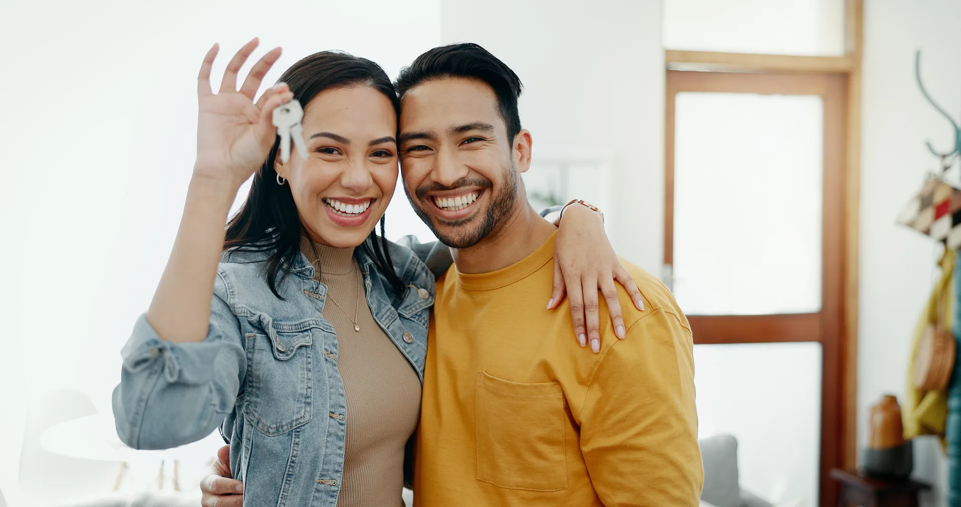 New home keys, hug and portrait of happy couple moving into house, real estate property or apartment purchase. Love, homeowner smile and Mexican man, woman or relocation people emb
