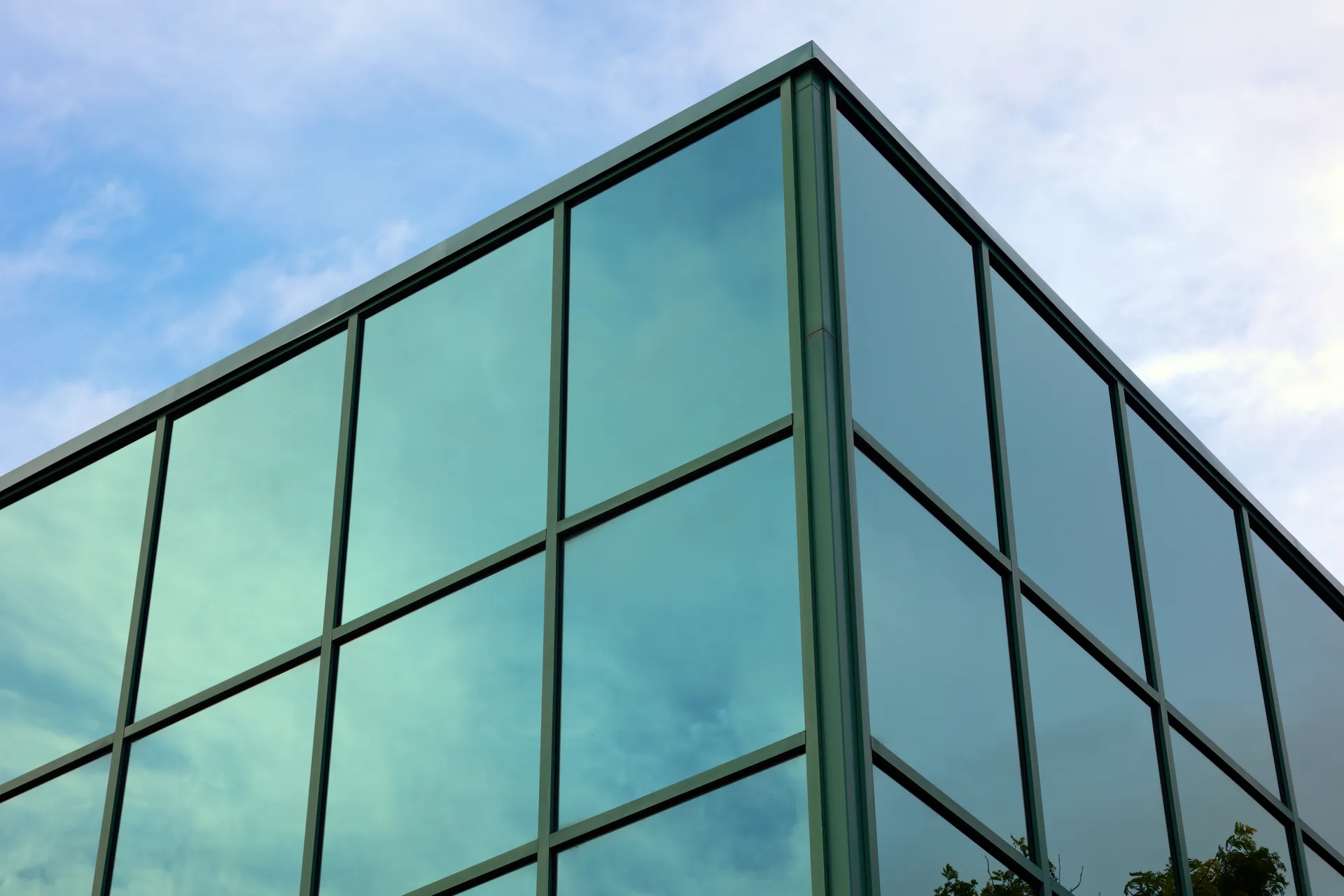 Modern Glass Corner Office Building with Reflective Windows